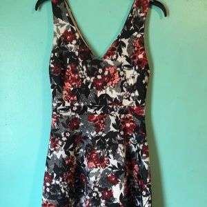 Deep v-neck dress with floral designs.